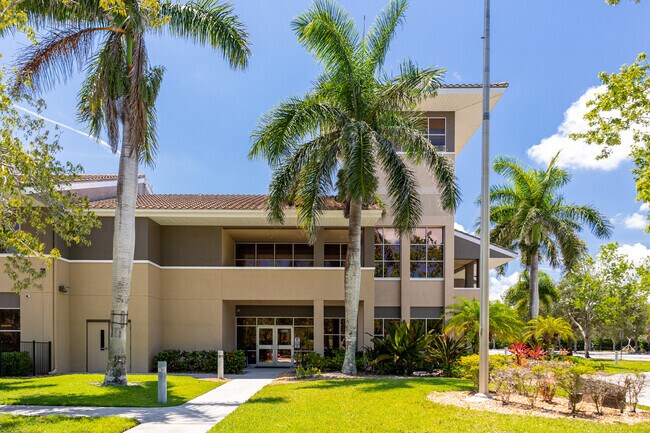 Progressive Pathways Academy in Naples is adorned with palm trees and shading trees.