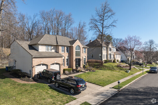 These New Traditional homes in Ravens Cliff are a mix or architectural styles combining the arched windows of the Dallas-style home with a steep roofline of a Chateau.