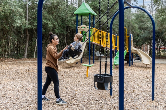 A mother and son enjoy a morning at Harper's Landing Park Playground in Harper's Landing.