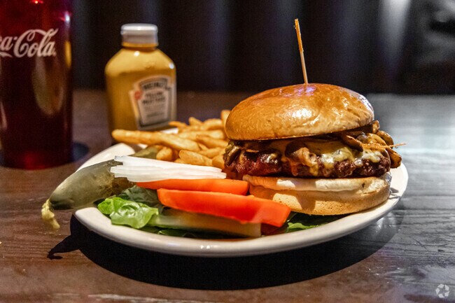 Savor a juicy and homemade burger at Embers Tavern, a cozy and friendly pub in Spring Hill.