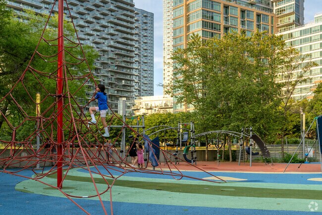 Fearless kids make their way to the top of the Rainbow Playground.