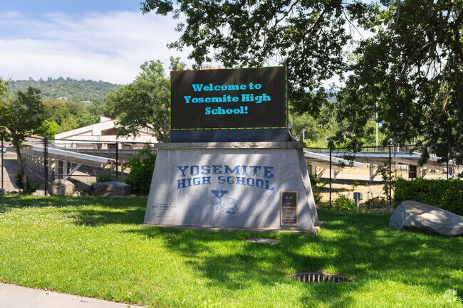 A lighted marquee at the entrance to Yosemite High School informs parents of events.