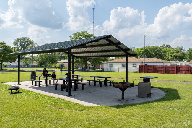 Visitors to Alfonso Wells Memorial Park can relax under its outdoor shade structures.