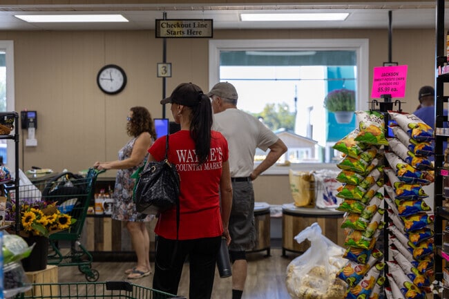 Shoppers browse fresh fruits and vegetables at Wayne’s Country Market in Lexington.
