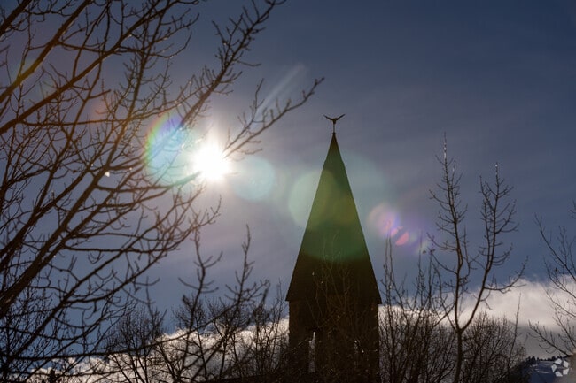 The sun shines over Aspen Chapel, creating a picturesque view near the West End.