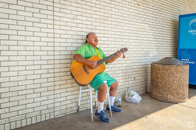Street performers are entertaining with live music outside La Michoacana Super Market in Owen Point.