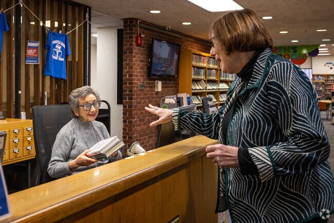 Taking out or returning books comes with a wide smile at the Springfield Free Public Library.