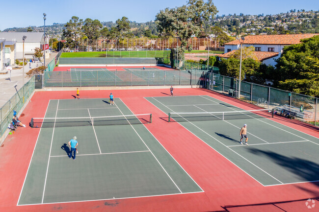 Residents stay athletic with a game of tennis in Memorial Park in Albany.