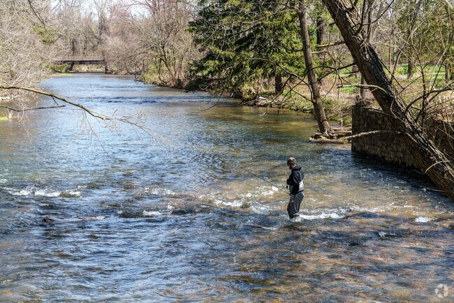 A South Bethlehem fisherman wades through the shallow waters of Saucon Creek.