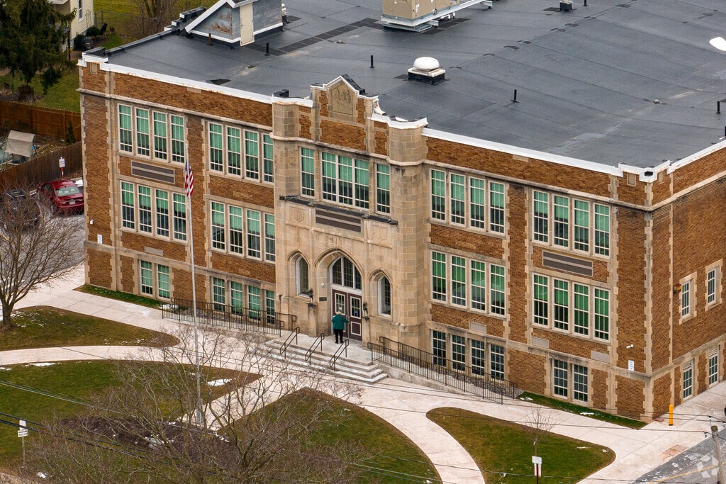A woman walks into the front door of Peterboro Street Elementary in Canastota.