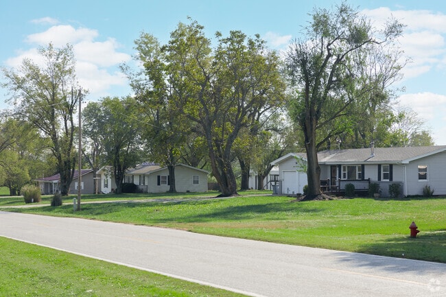Ranch-style homes line a quiet two-lane road in West Springfield’s rural landscape.