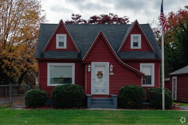 This small colonial style homes has an eclectic touch of saltbox design.