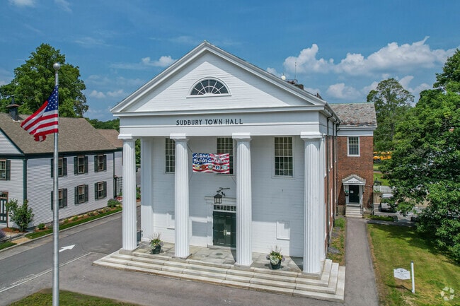 The Sudbury Town Hall sits at the heart of the city next to historical buildings.