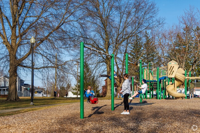 Children play and swing on the playground at Oak Hill Park.