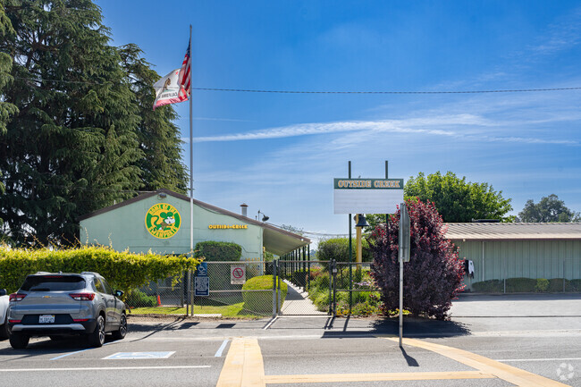 An American flag waves at the entrance to Outside Creek Elementary School.