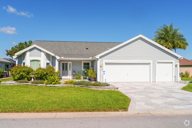 A three-car garage provides a great space for the golf cart in this Village of Palo Alto home.