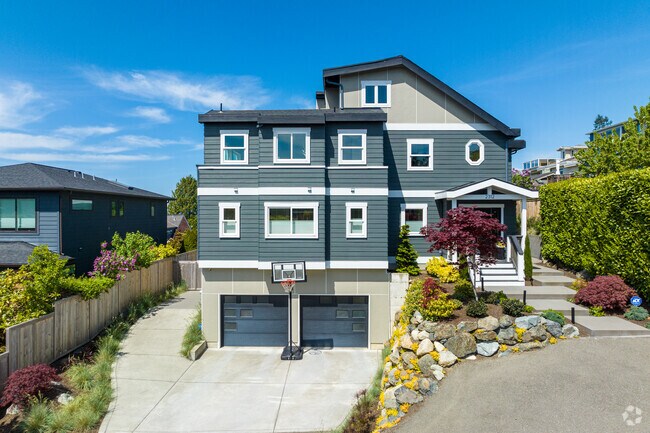 This beautiful three-story home in North Beach features a large driveway and a two-car garage.