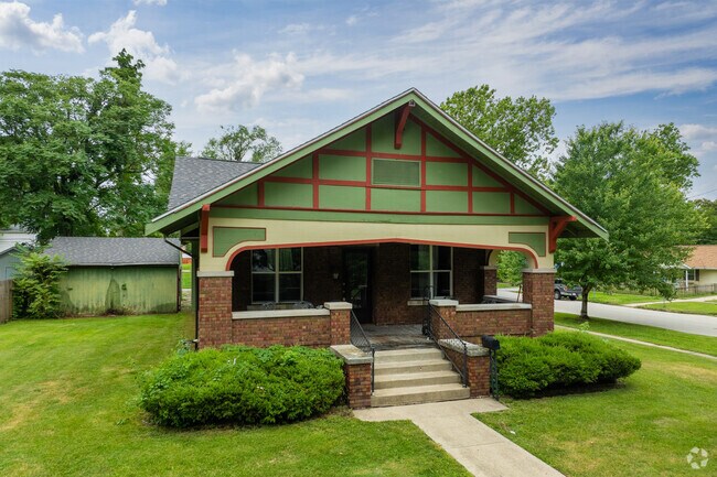 This green and red arts and crafts home is an example of the historic architecture of Enos Park.