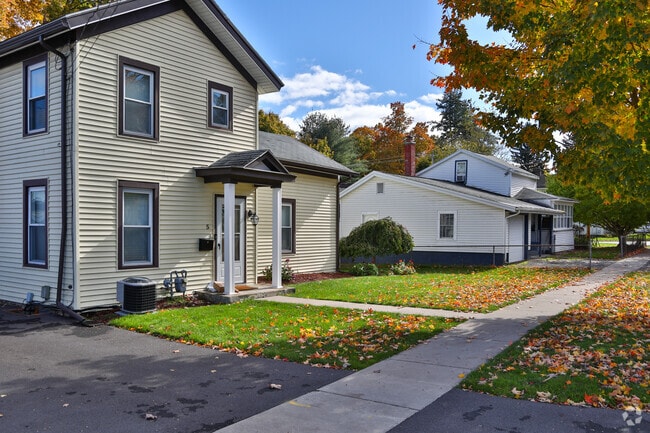 Homes in Baldwinsville have small front yards with trees, providing shade in the warmer  months.