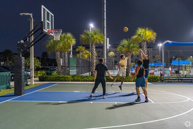 Many residents play basketball at Doral Legacy Park after sunset in Islands at Doral.