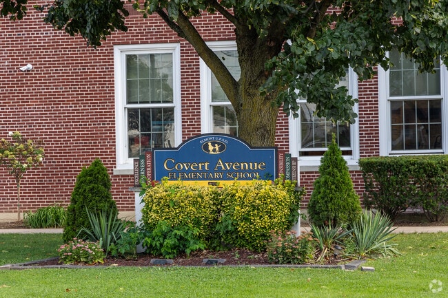Covert Avenue Elementary School's signage is visible in its impeccably kept front garden.