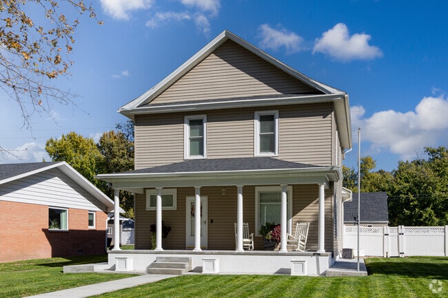 A classic two‑story Minden home showcases a broad porch for gatherings.