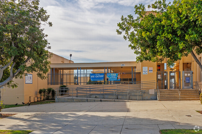 Whittier Elementary entrance is framed by trees.