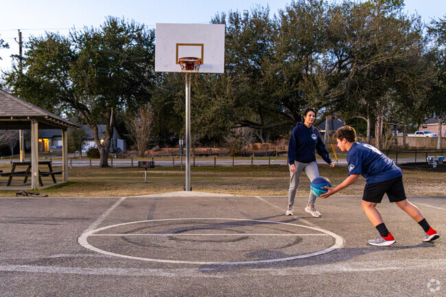 A mother and son play an evening game of basketball at East Rec Park in Diamondhead.
