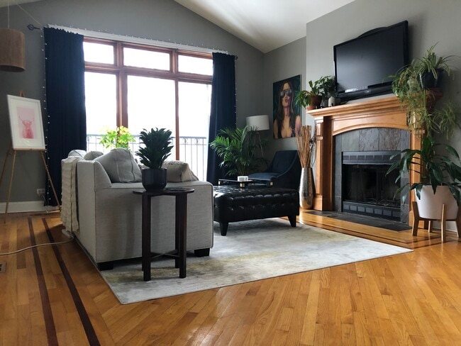 Living room with furniture. Sliding doors overlook street.