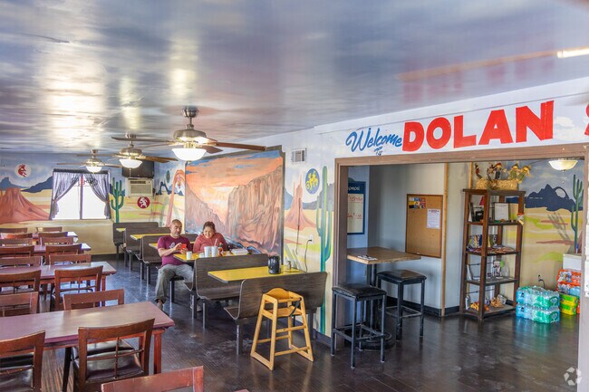Inside Canyon Café, colorful murals and cozy seating welcome diners.