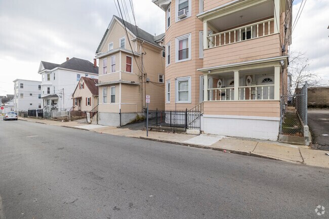 This triple-decker home in Lawrence offers classic design with spacious living.