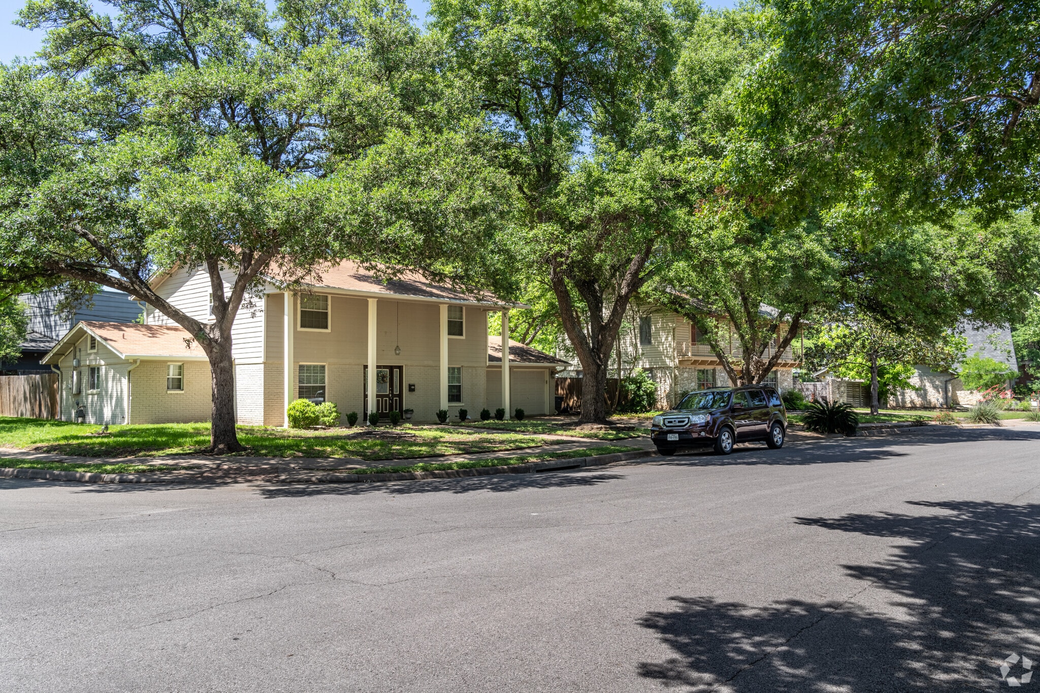 Most homes in Allandale have large trees provided shade in the front lawn.