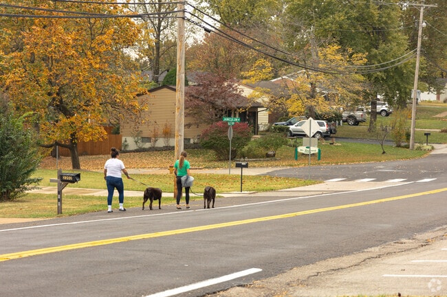 People take a stroll by the park in Peerless Park.