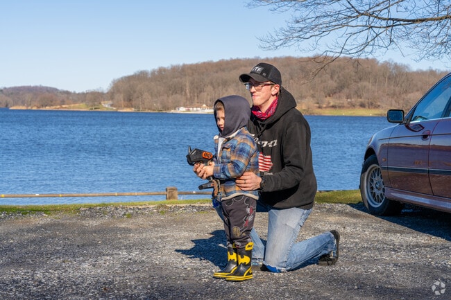 A father and son enjoy remote control cars at Marsh Creek Lake nearby East Brandywine.