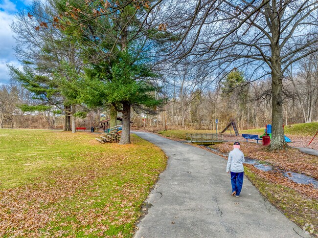 A resident takes a walk on the paved trails of Richardson Park.