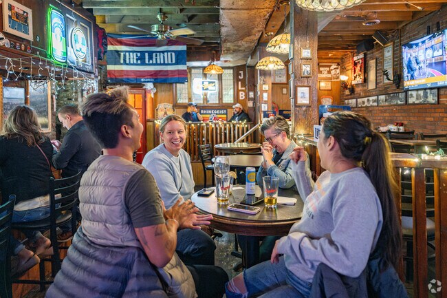 Friends gather at Johnny's Little Bar in Warehouse District for a drink and a laugh.