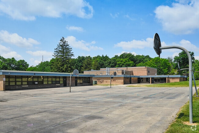 Behind Abbot Elementary there are multiple basketball courts.