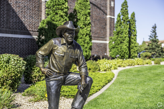 You find a statue of Ronald Reagan outside of a boot store near Village West.
