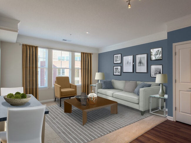 Carpeted living and dining area with accent wall