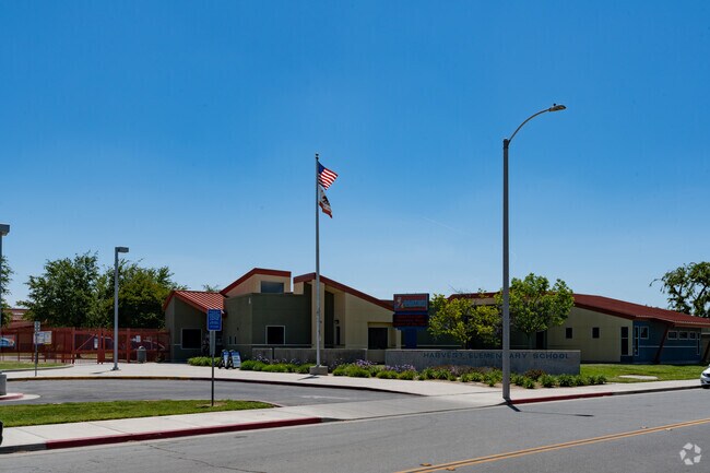 The flag flies high in front of Harvest Elementary.