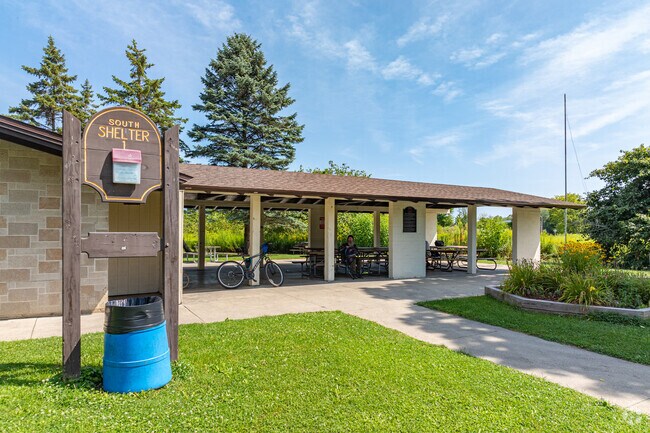 A biker cools off in the shade of the picnic shelter in Pritchard Park.