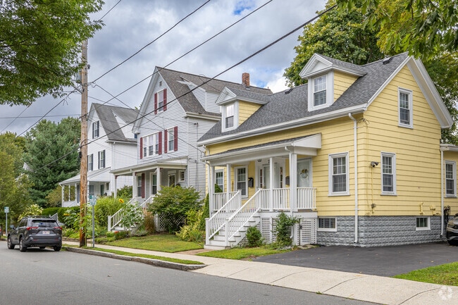 A row of homes including a colorful Cape Cod style home along with New Englander style homes in the Wyoming neighborhood of Melrose, MA.