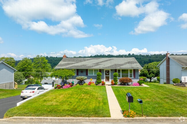 A tidy front yard complements this ranch-style residence in rural Pennsylvania.