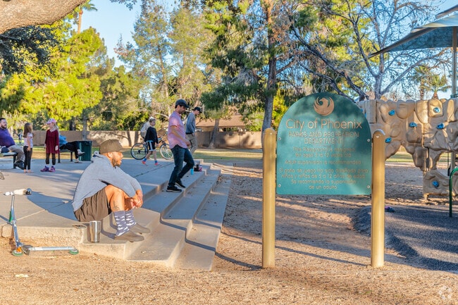 Parents watch their children play at Royal Palm Park in North Mountain Village.