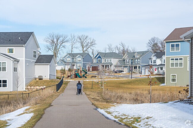 A resident makes their way to the playground in the Bailey Meadows housing development.