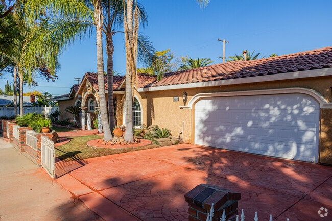Spanish revival home has a clay-colored driveway in Central Modesto.
