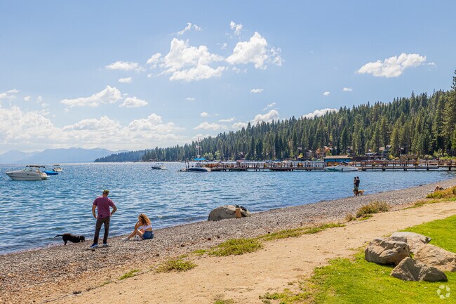A couple enjoys a beach day with their dog on Carnelian Bay West Beach.