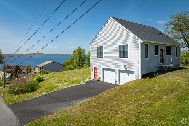 A picturesque row of homes sits atop a hill, offering stunning bay views in North Tiverton, RI.