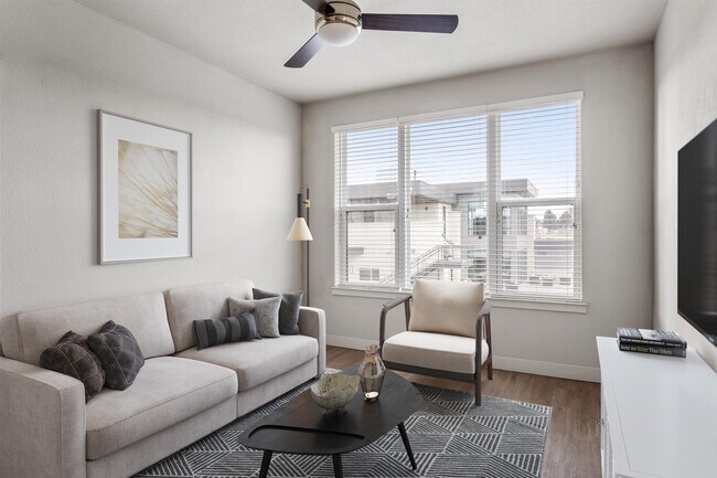 Modern Living Room with Ceiling Fan and Large Windows