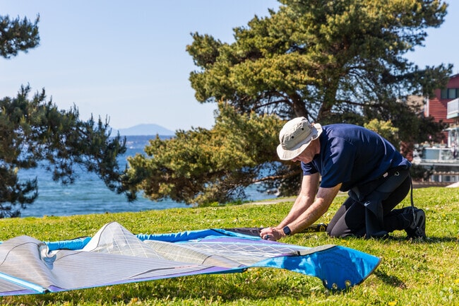 Across the street from Me-Kwa-Mooks Park, a windsurfer gears up for fun in the sun in Alki.